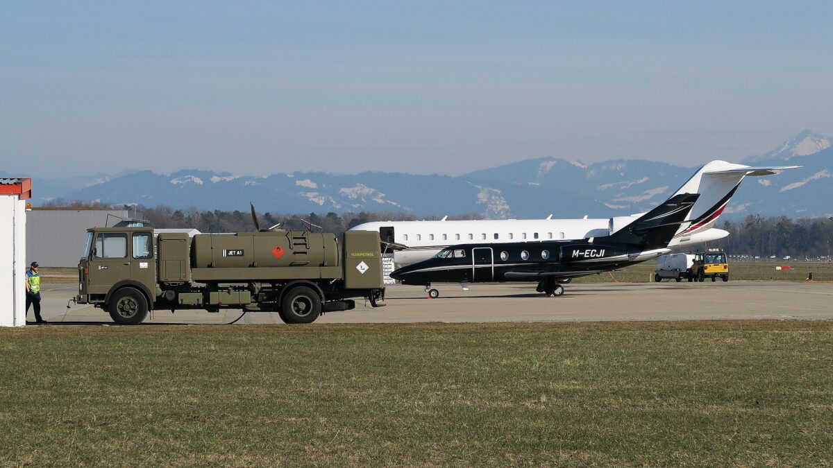 Jet-fuel tanker beside two business aircraft at St. Gallen-Altenrhein Airport in Switzerland