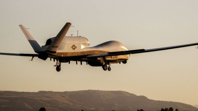 U.S. Navy MQ-4C Triton at NAS Sigonella, used to illustrate Denmark and NATO maritime surveillance orders.