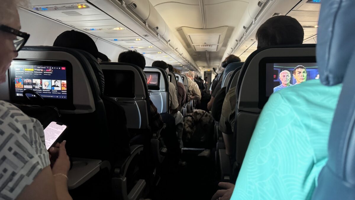 Delta Air Lines economy cabin, used to illustrate a service dog aisle behavior debate.