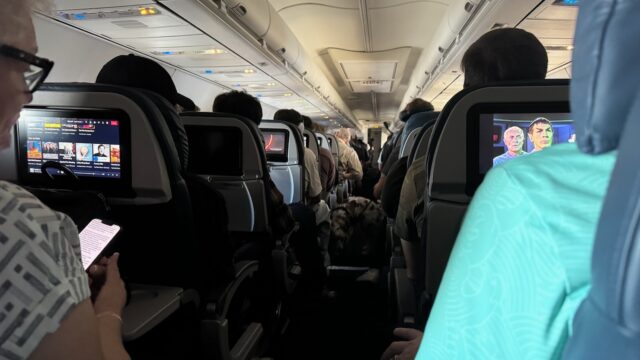 Delta Air Lines economy cabin, used to illustrate a service dog aisle behavior debate.